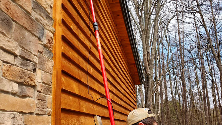 Jon Kauffman, assistant program director at Shaver’s Creek, uses a Borescope (attached to an old pruning saw) to check for bats in an existing box.