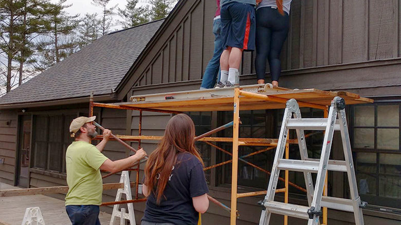 Positioning the box on the wall takes many hands.
