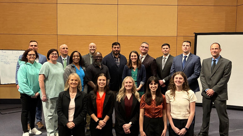 Penn State Altoona students Ally Black (first row, second from left), Devlin Glenn (first row, third from left), Abigail Hayes (first row, fourth from left), and Katelyn Kurtz (first row, fifth from left) join their mentor Dr. Nathan E. Kruis, (last row, first from left) and representatives from Penn State Health and the Pennsylvania State Police at the Keystone Model of Crisis Management workshop held at Penn State Great Valley on April 28, 2025.