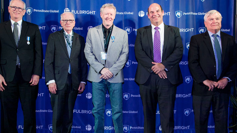 Professor Mark Agee poses for a photo with Penn State administrators at a celebration of the 75th anniversary of the Fulbright program