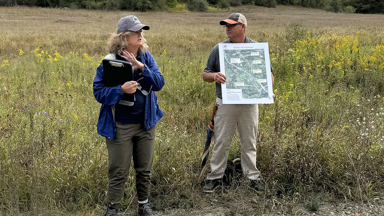 Two people stand in a field