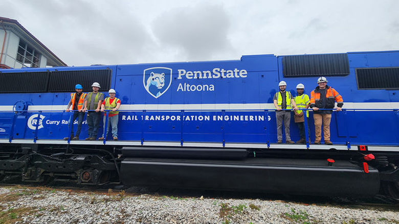 Penn State Altoona Rail Transportation Engineering students pose on the PSU 2020 locomotive.