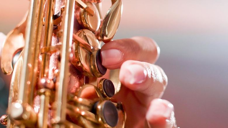 A closeup of someone playing a saxophone