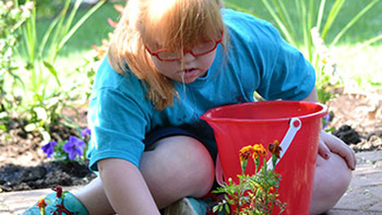 A child plays in the Sensory Garden