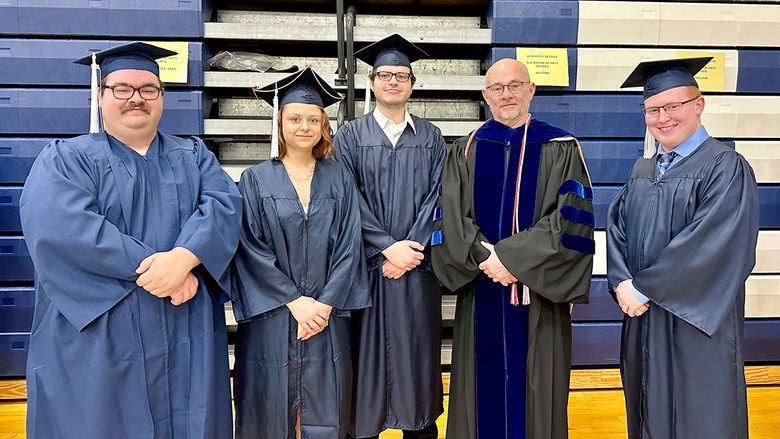 Spring 2023 graduates Joseph Gagermeier, Alicia Qatipi, Matthew Wolff, and Noah Plank standing with Teaching Professor Doug Page.