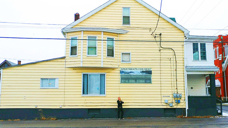 Taylor Stoudnour in front of one of her rental properties