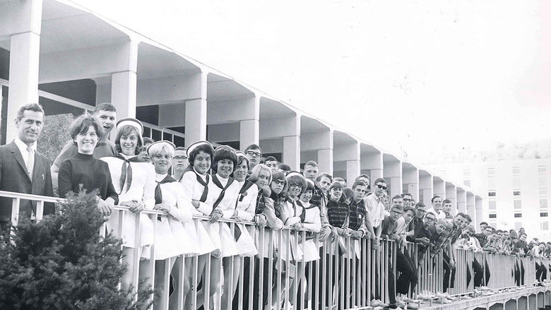 Students, faculty, and staff pose for a photo on the portico of the Slep Student Center in a photo taken in the 1970s.