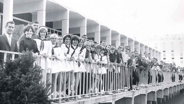 Students, faculty, and staff pose for a photo on the portico of the Slep Student Center in a photo taken in the 1970s.