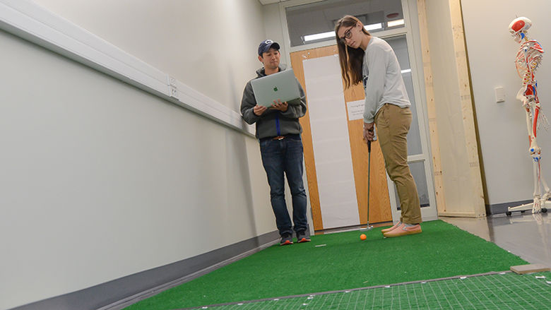 Takehiro Iwatsuki and kinesiology major Kierra Irwin work together on Iwatsuki's research regarding motor skills.