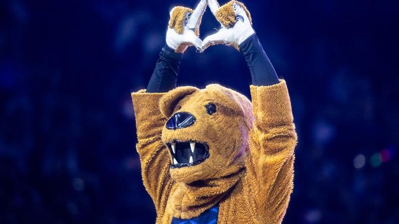 The Penn State Nittany Lion mascot holds his hands above his head forming a diamond during the annual THON fundraiser.