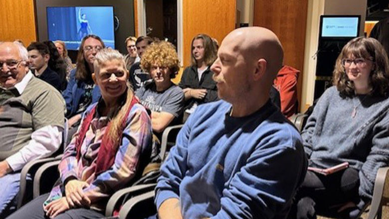 The crowd enjoys a joke by Jeffery Stoyanoff, assistant professor of English and Women's, Gender, and Sexuality Studies.
