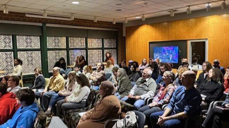 The audience enjoys the open mic event.