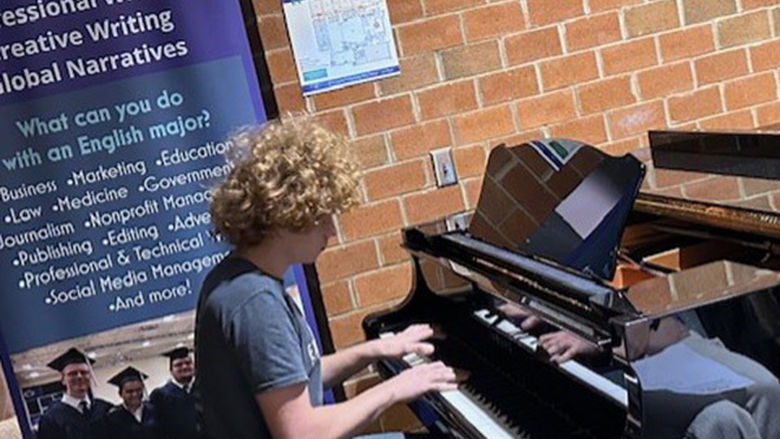 Levi Custer performs an original song on piano.