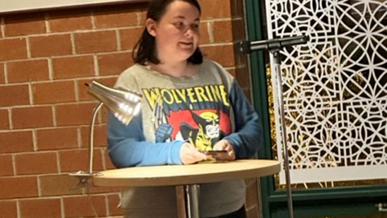 Student Bloom Wertz reads a character sketch she wrote in the campus Creative Writing Club.
