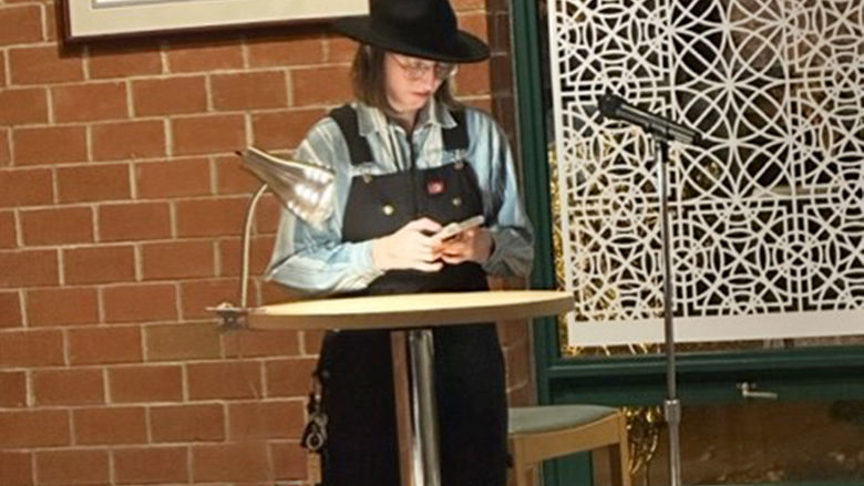 Student Emma Moniz reads her work.