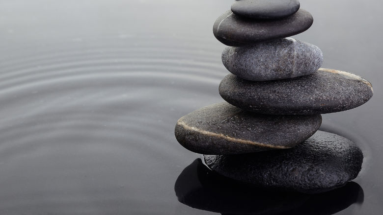 A stack of stones in a shallow pool of water