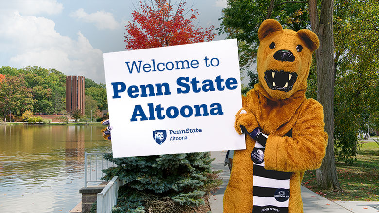 Nittany Lion holding a sign welcoming people to Penn State Altoona
