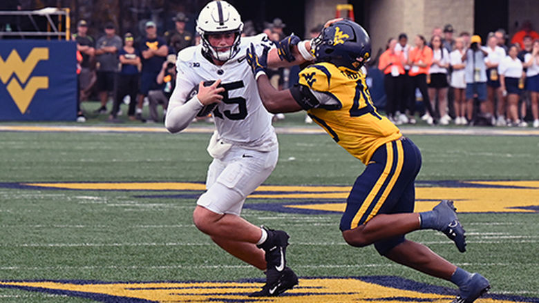 Drew Allar stiff arms West Virginia defender