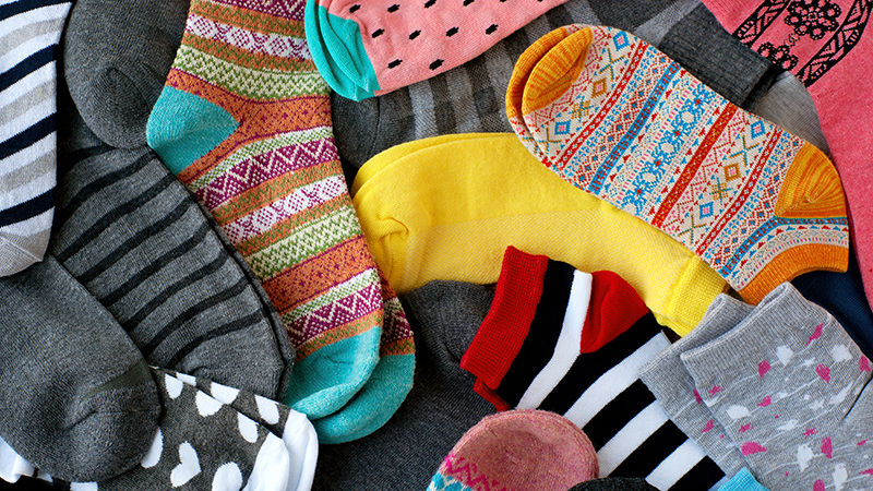 A piles of socks of varying shapes and sizes