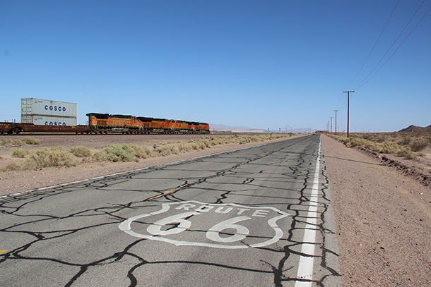 photo of US Route 66 with railroad in the background