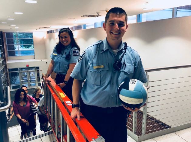 Student auxiliary officers retrieve volleyball