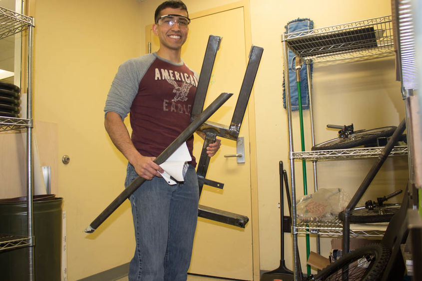 James Smith works with the pieces that will soon create Penn State's Human Powered Vehicle.