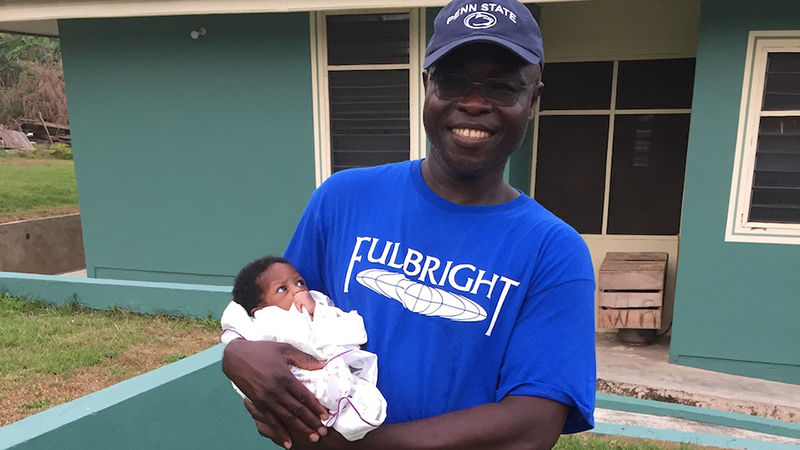 Kofi Adu with an infant from the Save Our Lives Orphanage