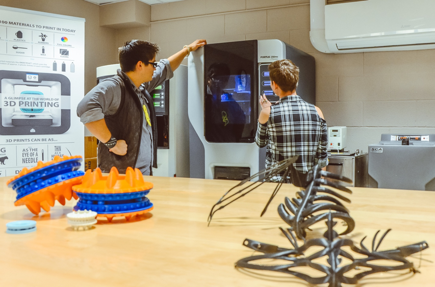 Students wait for 3D printed models to finish in lab space