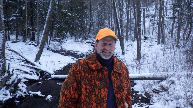 Todd Davis hiking through the snowy woods