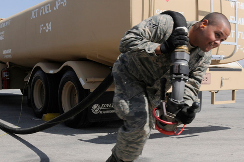 Soldier hauling jet fuel hose