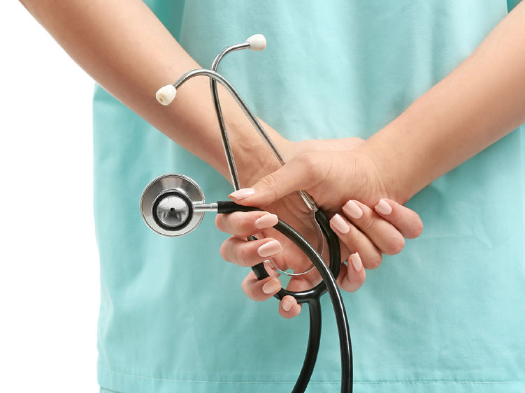 a nurse holding a stethoscope behind her back