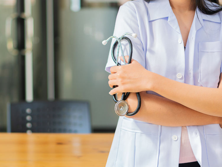 A female nurse holding a stethoscope