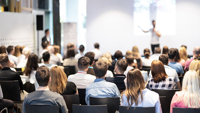 Students of various ages attending a business seminar