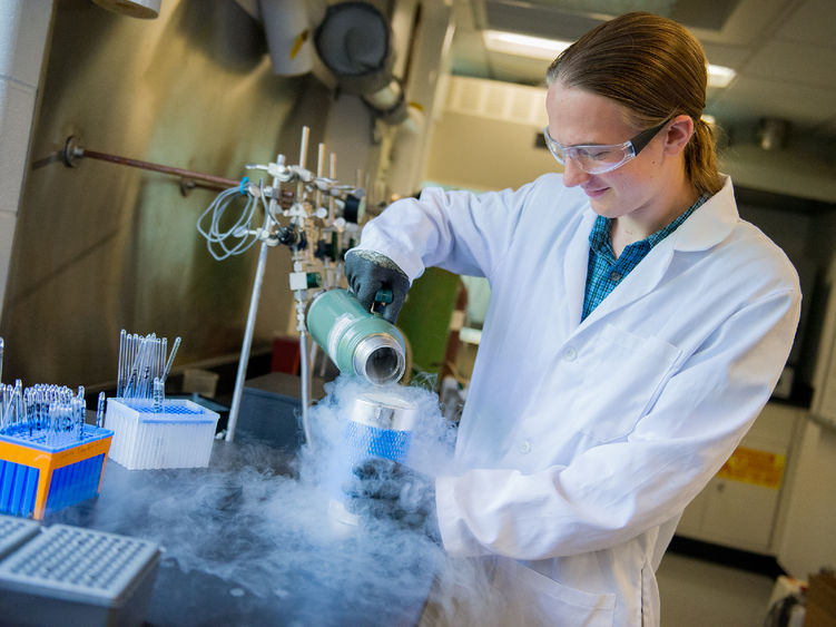 A student in a lab works on carbon dating materials