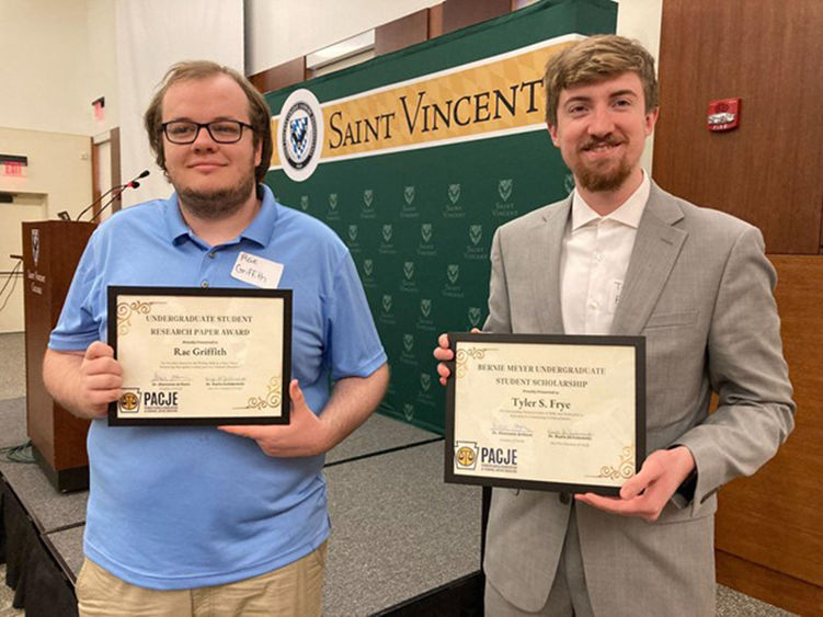 Rae Griffith (left) and Tyler Frye show off their awards from the PACJE conference.