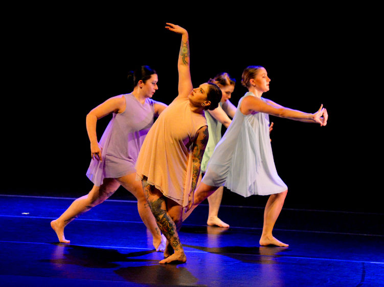 Several female dancers performing a modern dance