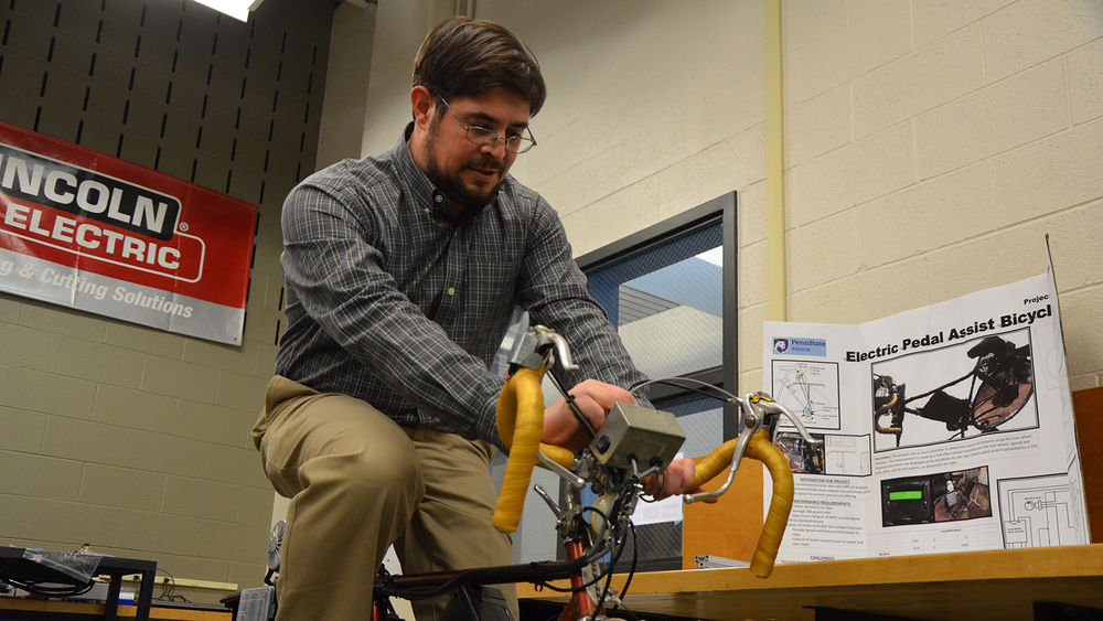 An engineering student demonstrates his project as part of the Student Showcase