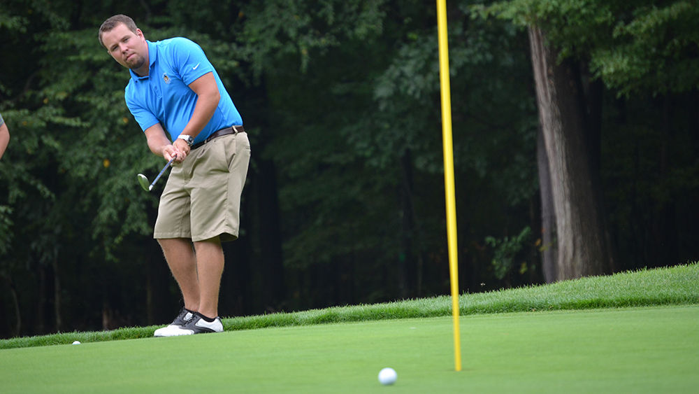 a player sinks a putt at the annual Penn State Altoona Community for Kids Golf Tournament