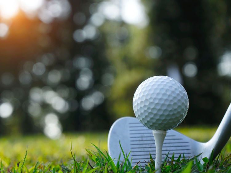 A golf ball and club