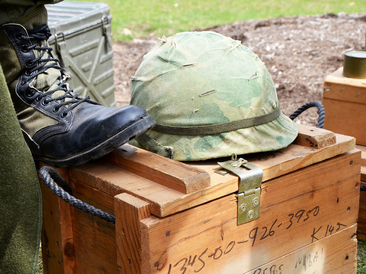 A military helmet sitting on top of a crate