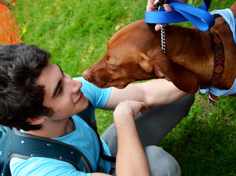 An Altoona student hanging out with a puppy at a Hugs for Hounds event