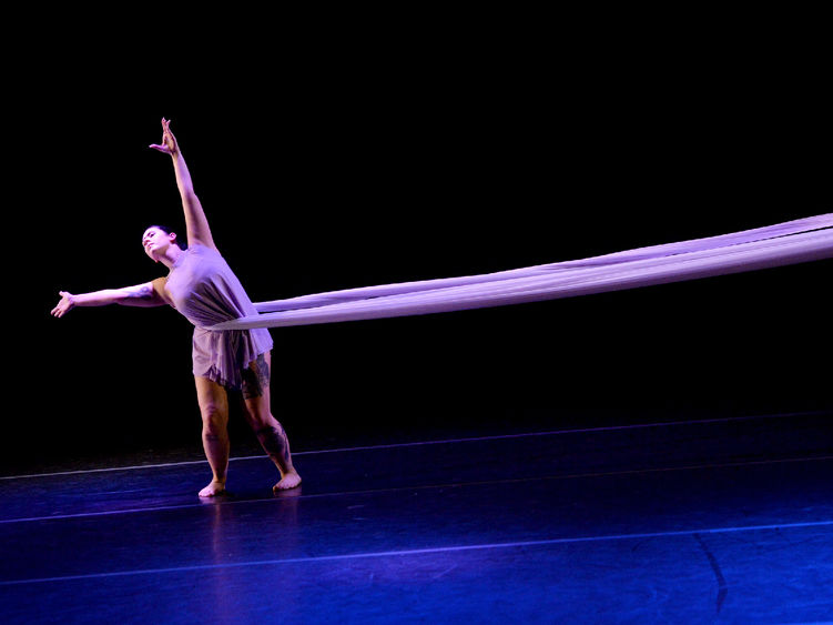 and Ivyside Dance Ensemble performer dances on the stage of the Wolf Kuhn Theatre