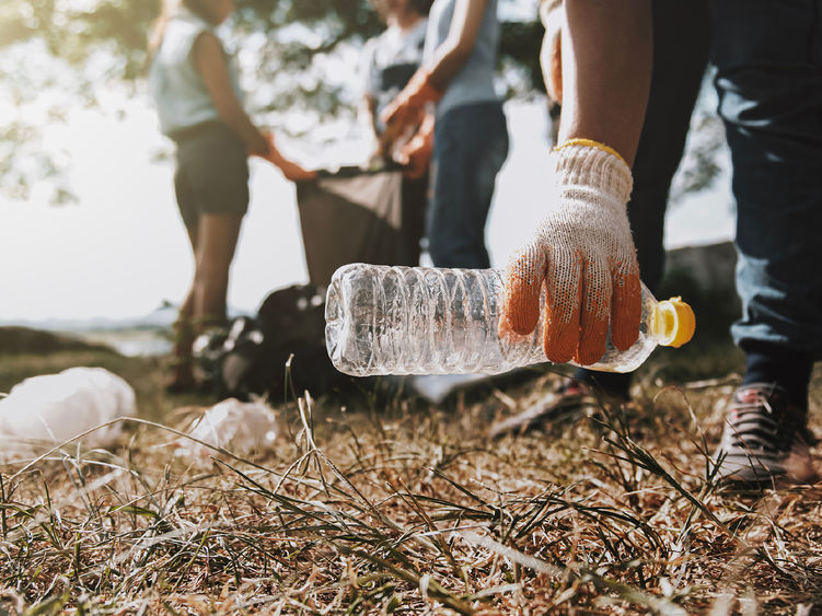 a group of people picking up litter alongside a street