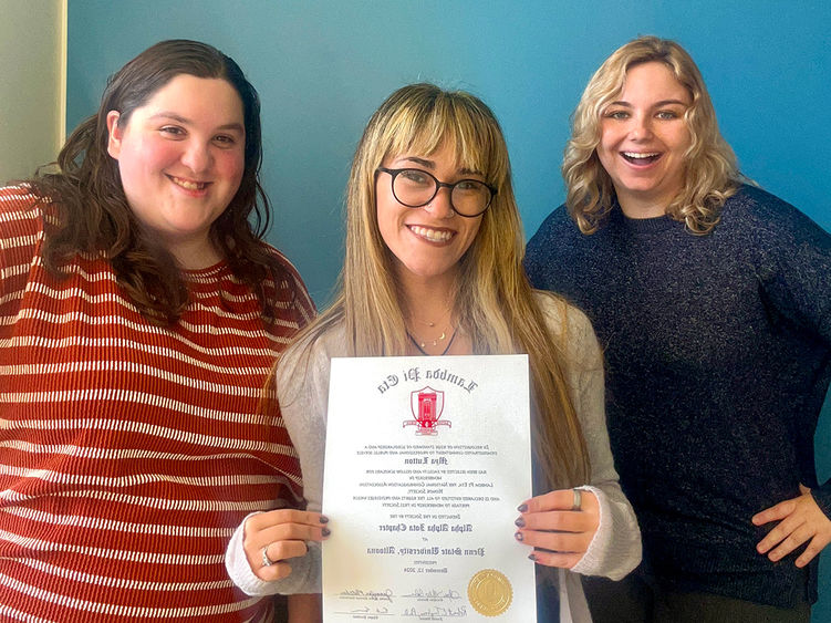 Communications major Mya Lutton displays her Lambda Pi Eta honor society certificate with recent Penn State Altoona graduates Eve Ergler and McKenzie Quirin.