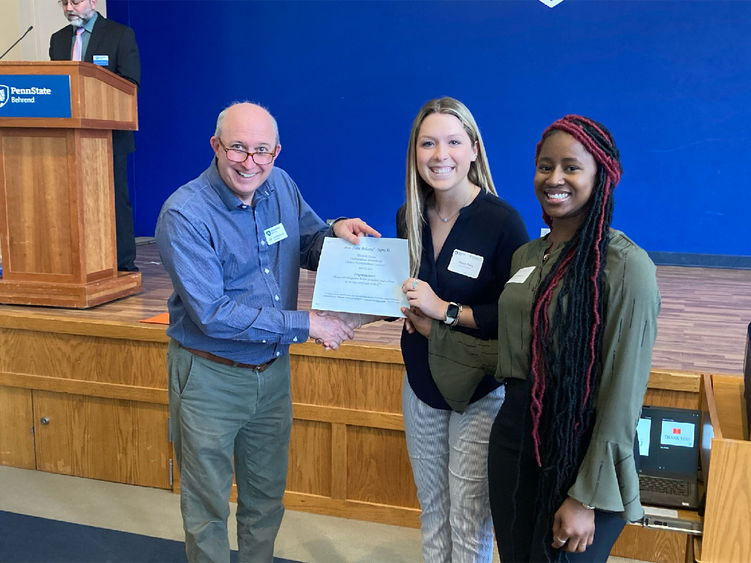 Penn State Altoona students Payton Perry and Makaylah Bangura receiving first place honors for their social sciences research poster at the spring 2022 Undergraduate Research and Creative Accomplishment Conference.