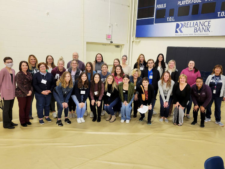 Student and faculty pose for a photo following a poverty simulation exercise at Penn State Altoona