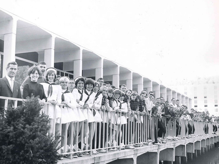 Students, faculty, and staff pose for a photo on the portico of the Slep Student Center in a photo taken in the 1970s.