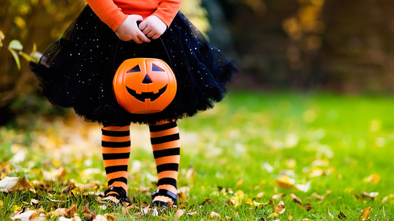 Young girl with trick or treat bucket