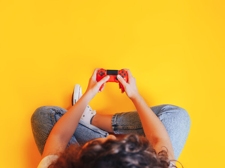 An overhead shot of a young person playing a video game