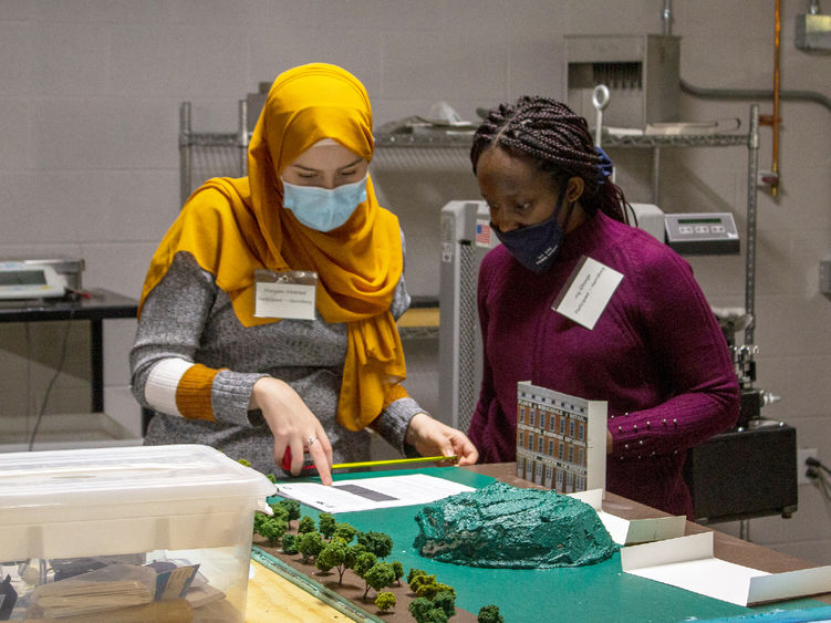 Two female engineering students work on a project as part of the 2021 Women in Engineering competition